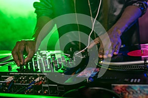 cropped view of professional african american club DJ with sound mixer