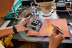 cropped view of professional technician examining