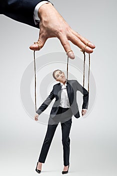 Cropped view of puppeteer holding businesswoman