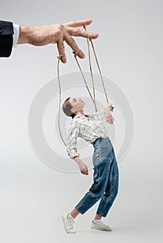 Cropped view of puppeteer holding marionette