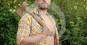 cropped view of rancher with axe outdoor. photo of rancher with axe. rancher with axe.