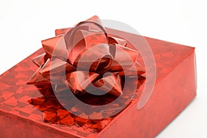 Cropped view of red shiny box with ribbon