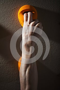 Cropped view of rock climber gripping handhold