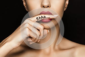 Cropped view of seductive woman with red lips showing shh symbol