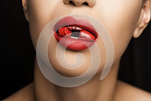 Cropped view of seductive woman with red lipstick in mouth