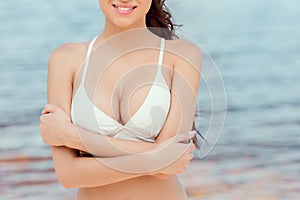 cropped view of sexy girl in white bikini posing