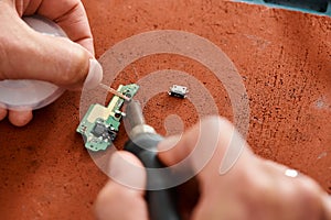 cropped view of skilled technician soldering