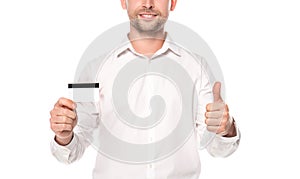 Cropped view of smiling businessman holding credit card and showing thumb up isolated on white