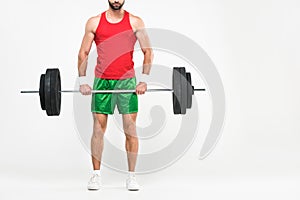cropped view of sportsman in retro sportswear holding barbell