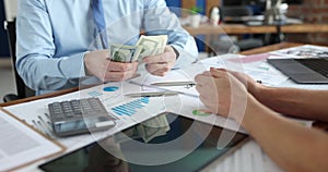 Cropped view of successful businessman counting money in front of manager