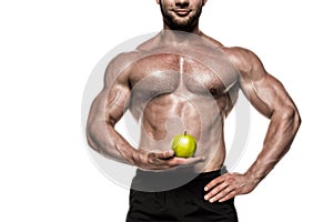 Cropped view of sweaty muscular sportsman holding green apple isolated on white