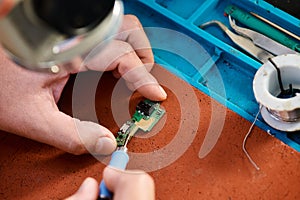 cropped view of technical specialist soldering