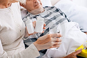 cropped view of wife giving glass