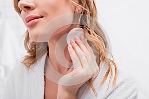 cropped view of woman applying toner