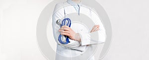 Cropped view of Woman Doctor in uniform standing and holding a stethoscope. Copy space