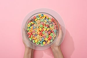 Cropped view of woman holding bright colorful breakfast cereal in bowl