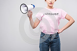 cropped view of woman in pink feminist t-shirt holding megaphone,