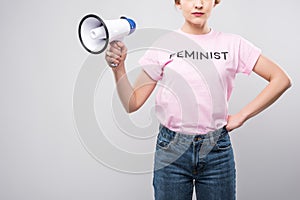 cropped view of woman in pink feminist t-shirt holding megaphone, photo