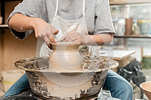 Cropped view of young female ceramicist photo