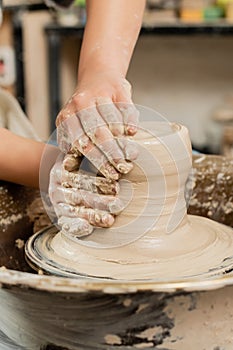 Cropped view of young female ceramicist photo