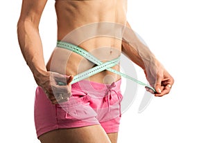 Cropped view of young fitness woman with measuring tape