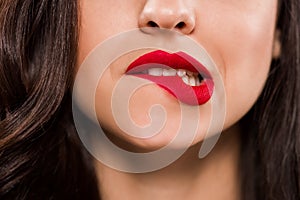 Cropped view of young woman biting