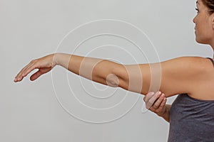 Cropped woman body showing arm with sagging skin