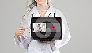 Cropped of woman doctor showing laptop computer with video call