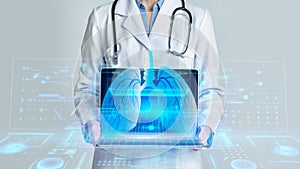 Cropped of woman doctor showing laptop, hologram of human lungs