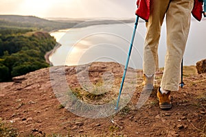 cropped Woman hiking in Autumn mountains, nordic walking, travelling concept