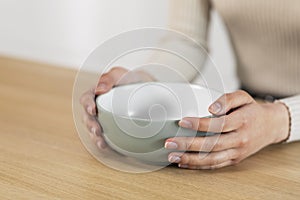 Cropped of woman holding empty plate, starving