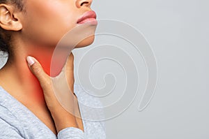 Cropped of woman suffering from sore throat, touching her neck