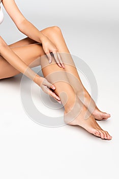 Cropped of woman touching smooth leg