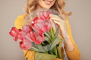 cropped woman with tulips. lady hold flowers for spring holiday. girl with bouquet