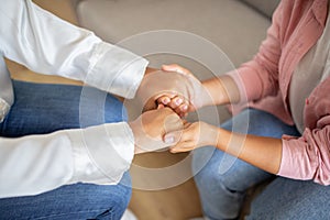 Cropped of young woman holding her therapist hands and smiling