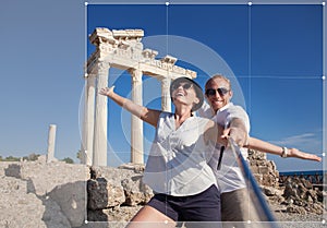 Cropping for social networks post photo of young couple on antique ruins