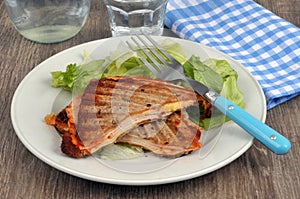 Croque-monsieur cut in half served on a plate with salad