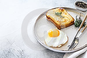 Croque Monsieur a traditional French toasted cheese and ham sandwich with bechamel sauce. White background. Top view