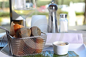 Croquettes of various flavors in a metal basket photo