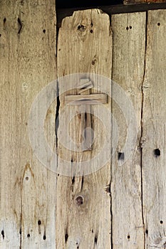 Cross against an old wooden house in Le Frenalay, French Alps