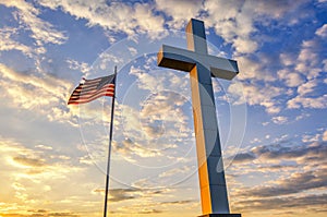 Cross and American Flag at sunset