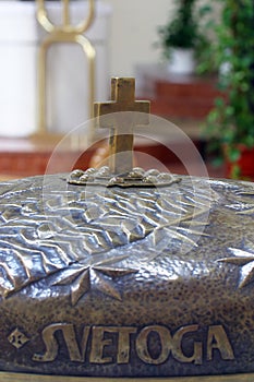 Cross on the baptismal font in the church of St. Paul in Retkovec, Zagreb, Croatia