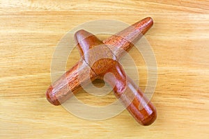 Cross bar wooden stick used as tool for traditional reflexology massage, Thai massage with better grip
