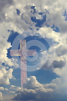 Cross behind clouds