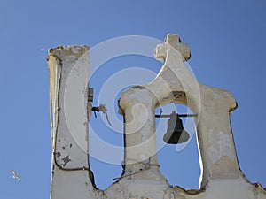 Cross and bell on the top of an old church in Gallipoli