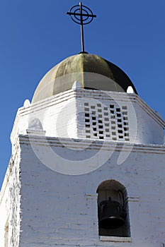 Cross On Bell Tower Against Blue Sky photo
