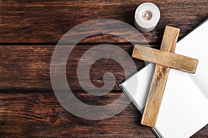 Cross, Bible and burning candle on background, flat lay with space for text. Christian religion