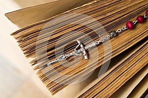 Cross on the Bible on a wooden background. Holy book