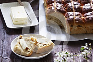 Cross buns served with butter, honey and tea. Easter breakfast.