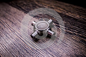 Cross of the cardan. Joint cross on wooden background